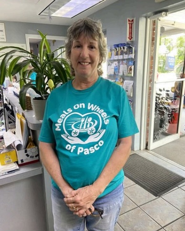 Linda Hatley wearing a Meals on Wheels of Pasco shirt